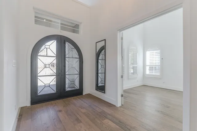 a view of a hallway view with wooden floor and staircase