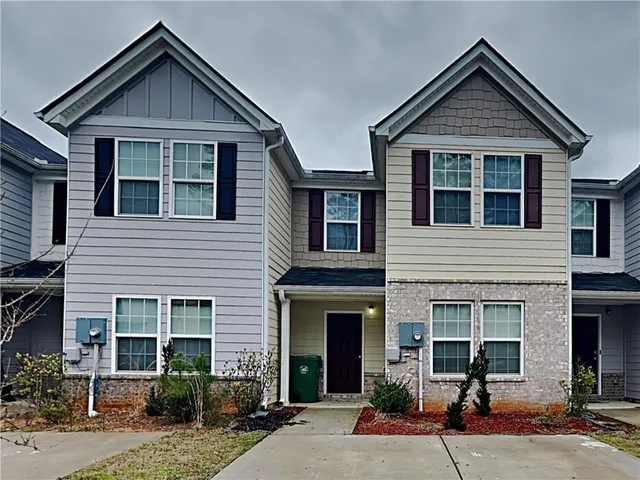 a front view of a house with yard