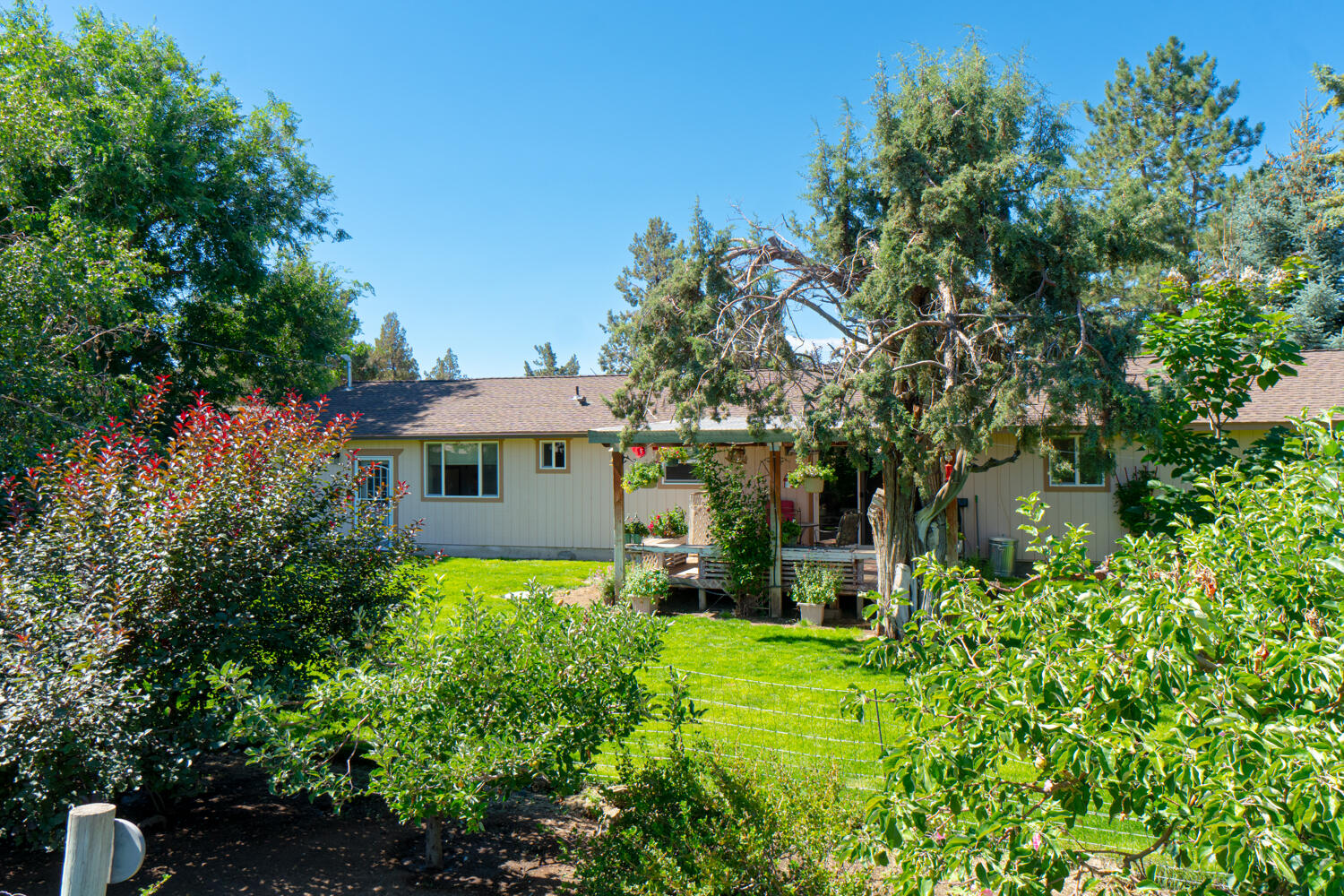 2218 Southwest 79th Street Redmond, OR 97756 - Photo 5 of 54 a front view of a house with garden