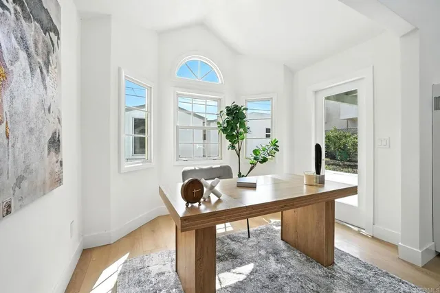 a vase of flowers sitting on a table with window