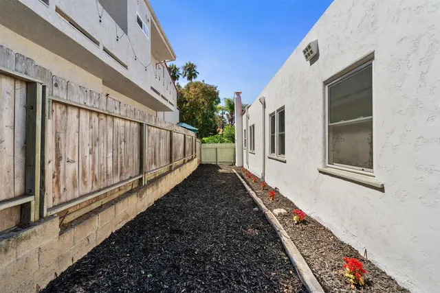 a front view of house with yard and trees around