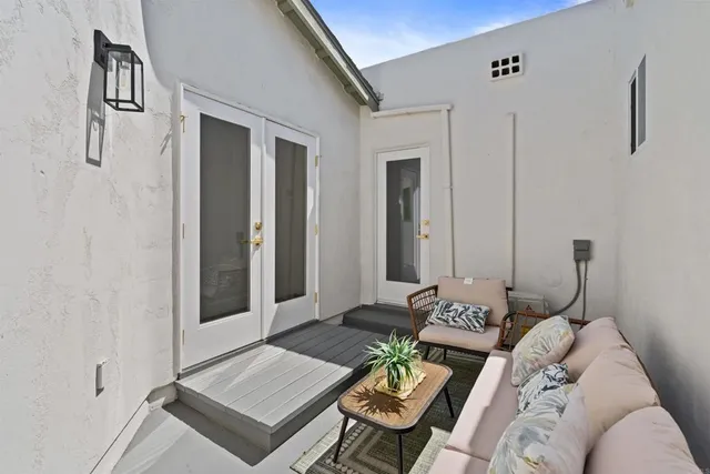 an aerial view of a city with lots of residential buildings ocean and mountain view in back