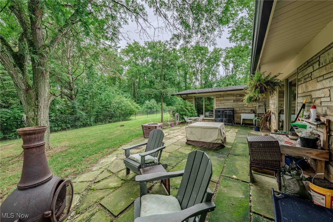 3381 Barrett Road Akron, OH 44333 - Photo 48 of 50 Fenced backyard with a patio area and an outdoor fire pit