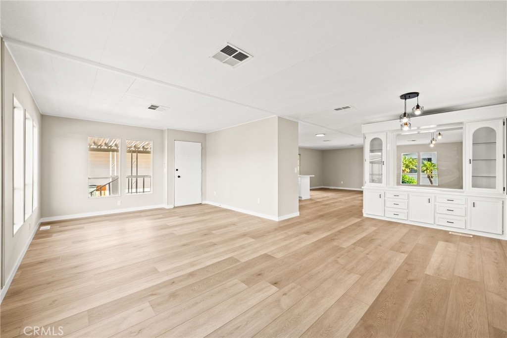 650 South Rancho Santa Fe Road, Unit 351 San Marcos, CA 92078 - Photo 4 of 56 a view of an empty room with window and wooden floor