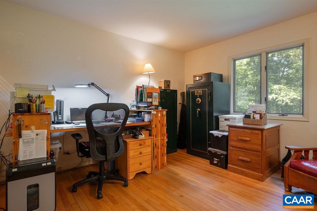 2110 Whippoorwill Road Charlottesville, VA 22901 - Photo 13 of 37 a view of a workspace with furniture and a window