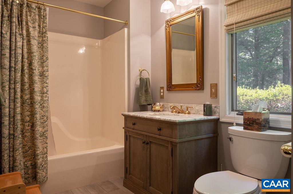 2110 Whippoorwill Road Charlottesville, VA 22901 - Photo 14 of 37 a bathroom with a sink toilet and shower