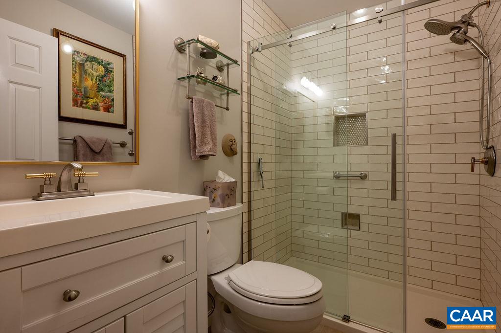 2110 Whippoorwill Road Charlottesville, VA 22901 - Photo 19 of 37 a bathroom with a sink a toilet and shower