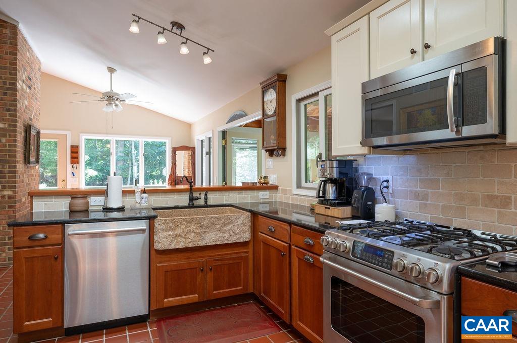 2110 Whippoorwill Road Charlottesville, VA 22901 - Photo 6 of 37 a kitchen with stainless steel appliances granite countertop a stove a sink and a microwave