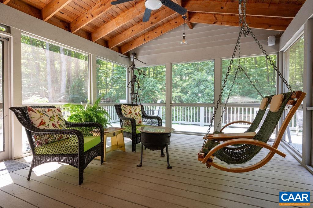 2110 Whippoorwill Road Charlottesville, VA 22901 - Photo 9 of 37 a view of a patio with couches chairs and wooden floor