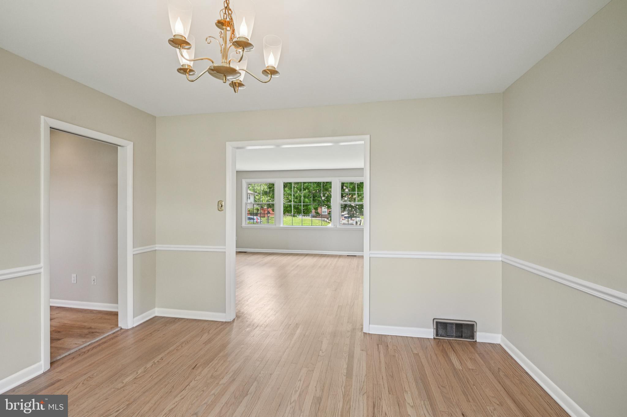 143 Ashbrook Road Cherry Hill, NJ 08034 - Photo 13 of 40 an empty room with wooden floor chandelier fan and windows