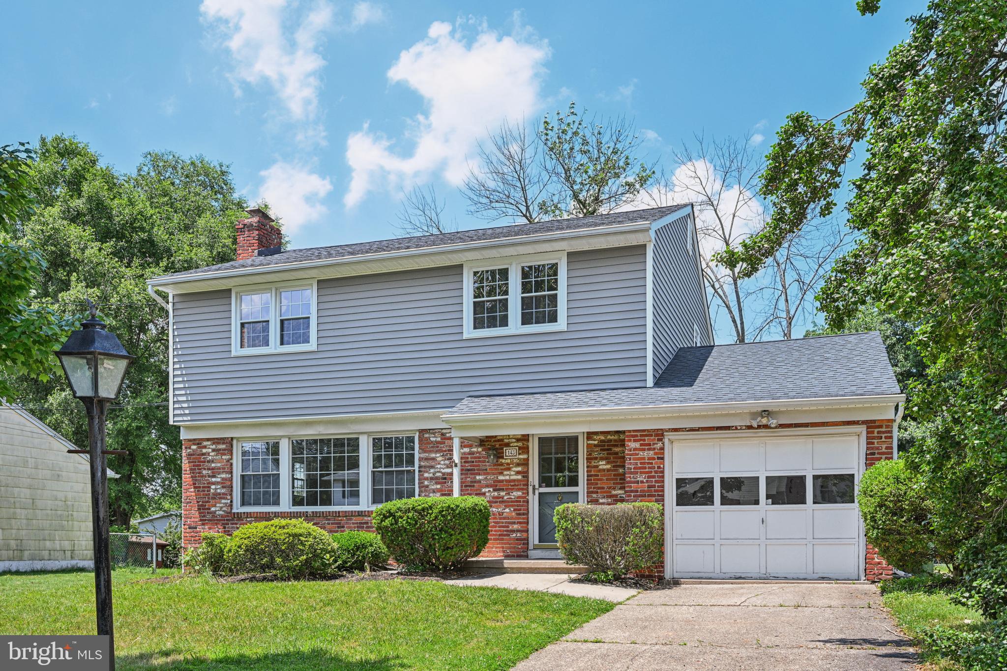 143 Ashbrook Road Cherry Hill, NJ 08034 - Photo 2 of 40 a view of a house with brick walls and a large tree