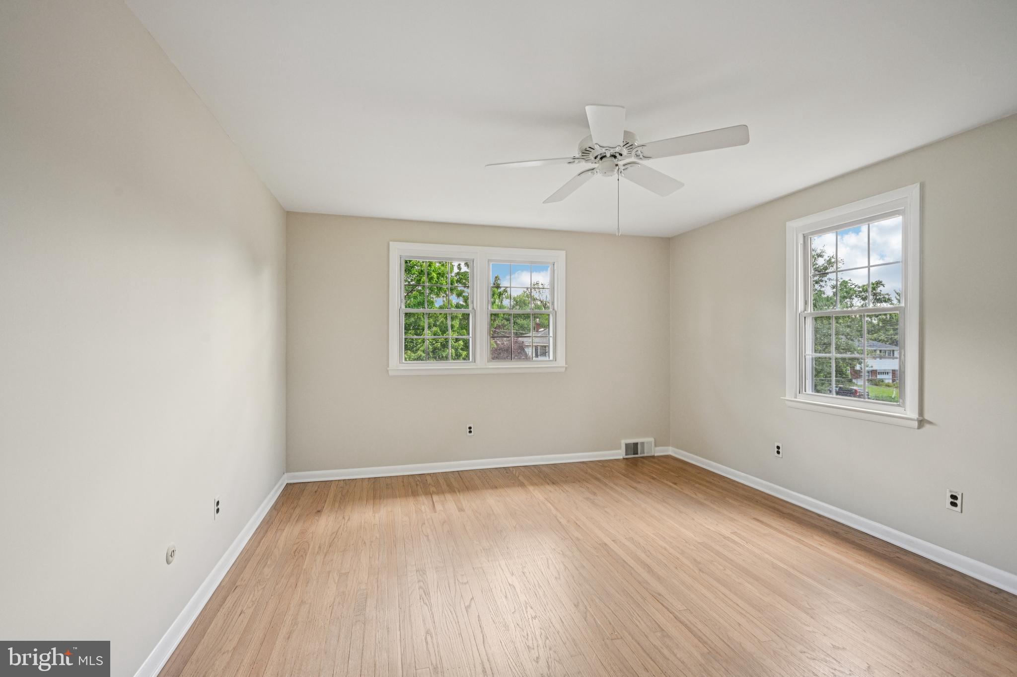 143 Ashbrook Road Cherry Hill, NJ 08034 - Photo 24 of 40 an empty room with wooden floor ceiling fan and windows