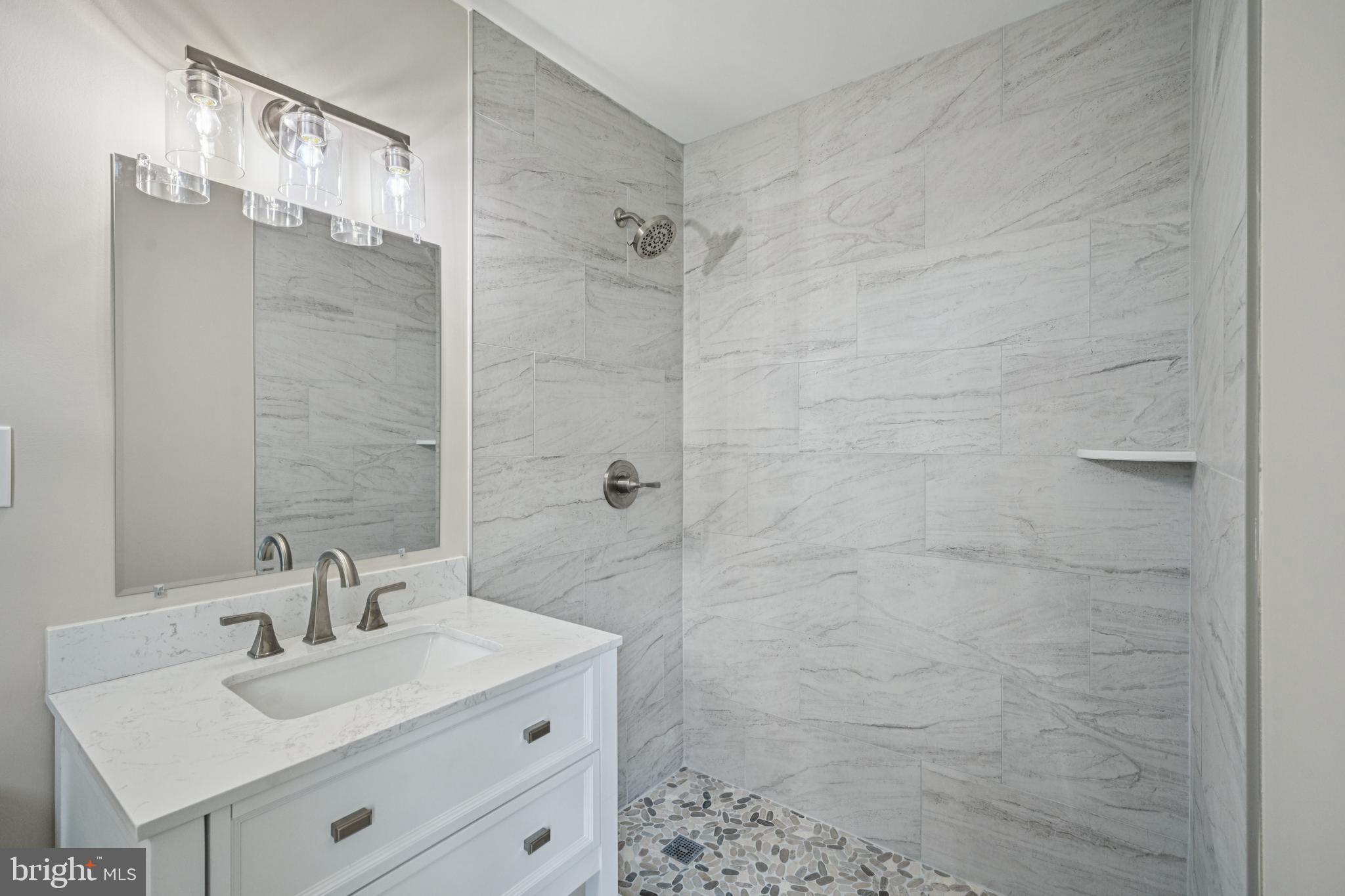143 Ashbrook Road Cherry Hill, NJ 08034 - Photo 29 of 40 a bathroom with a sink mirror and shower