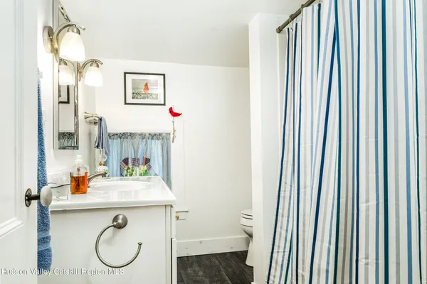 a bathroom with a sink toilet and a mirror