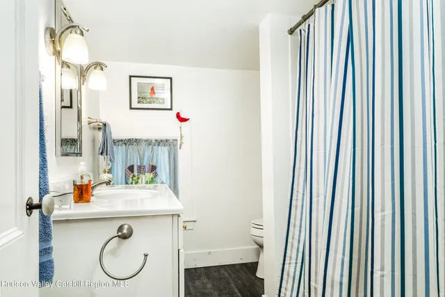 a bathroom with a sink toilet and a mirror