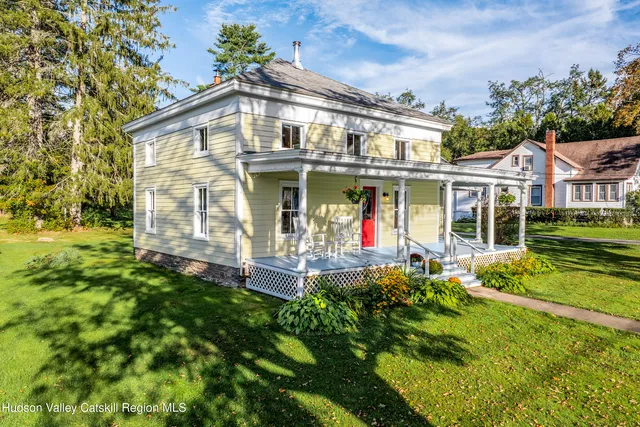 a front view of a house with a yard table and chairs