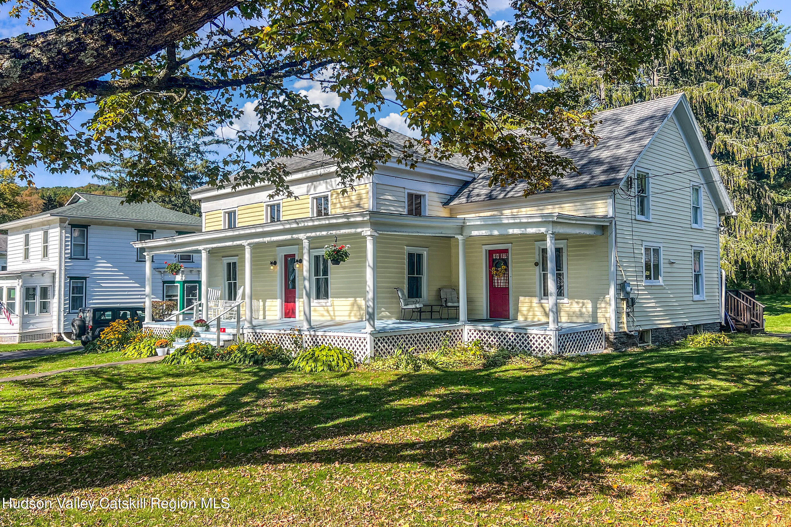 70 Case Hill Road Treadwell, NY 13846 - Photo 49 of 50 a front view of a house with a yard table and chairs