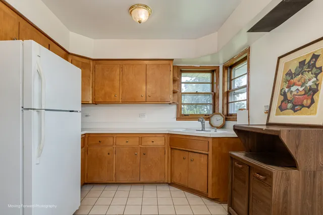 a kitchen with a sink appliances and cabinets