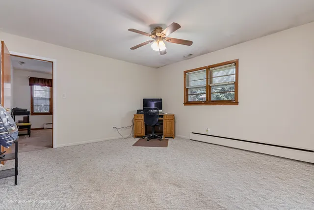 a room with furniture and a ceiling fan