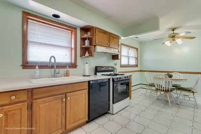 a kitchen with cabinets a sink and appliances