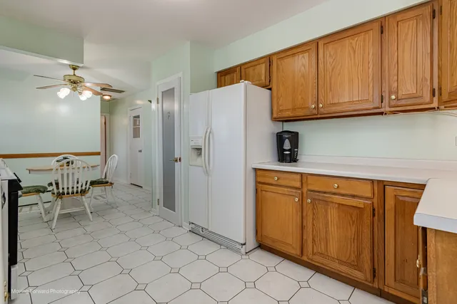 a kitchen with stainless steel appliances granite countertop a refrigerator and a stove top oven