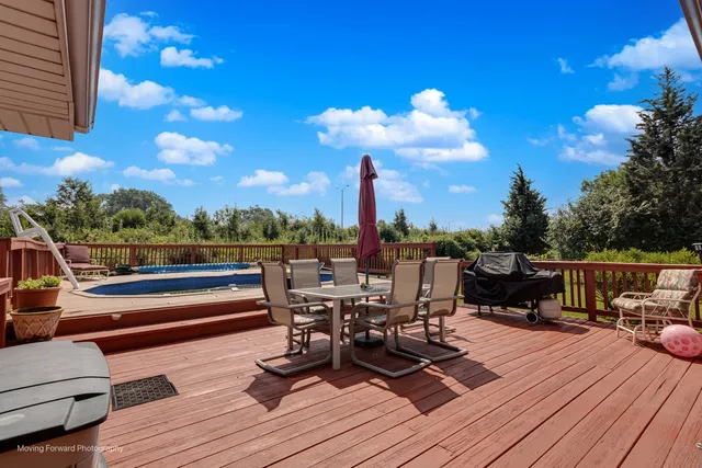 a view of house with swimming pool outdoor seating