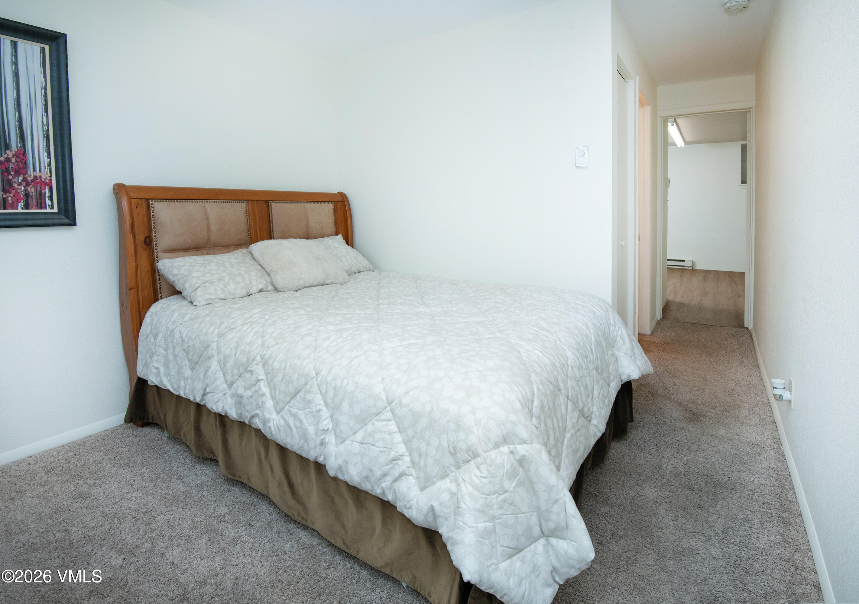 85 Chambers Avenue, Unit 10 Eagle, CO 81631 - Photo 21 of 41 a bed sitting in a bedroom next to a bathroom