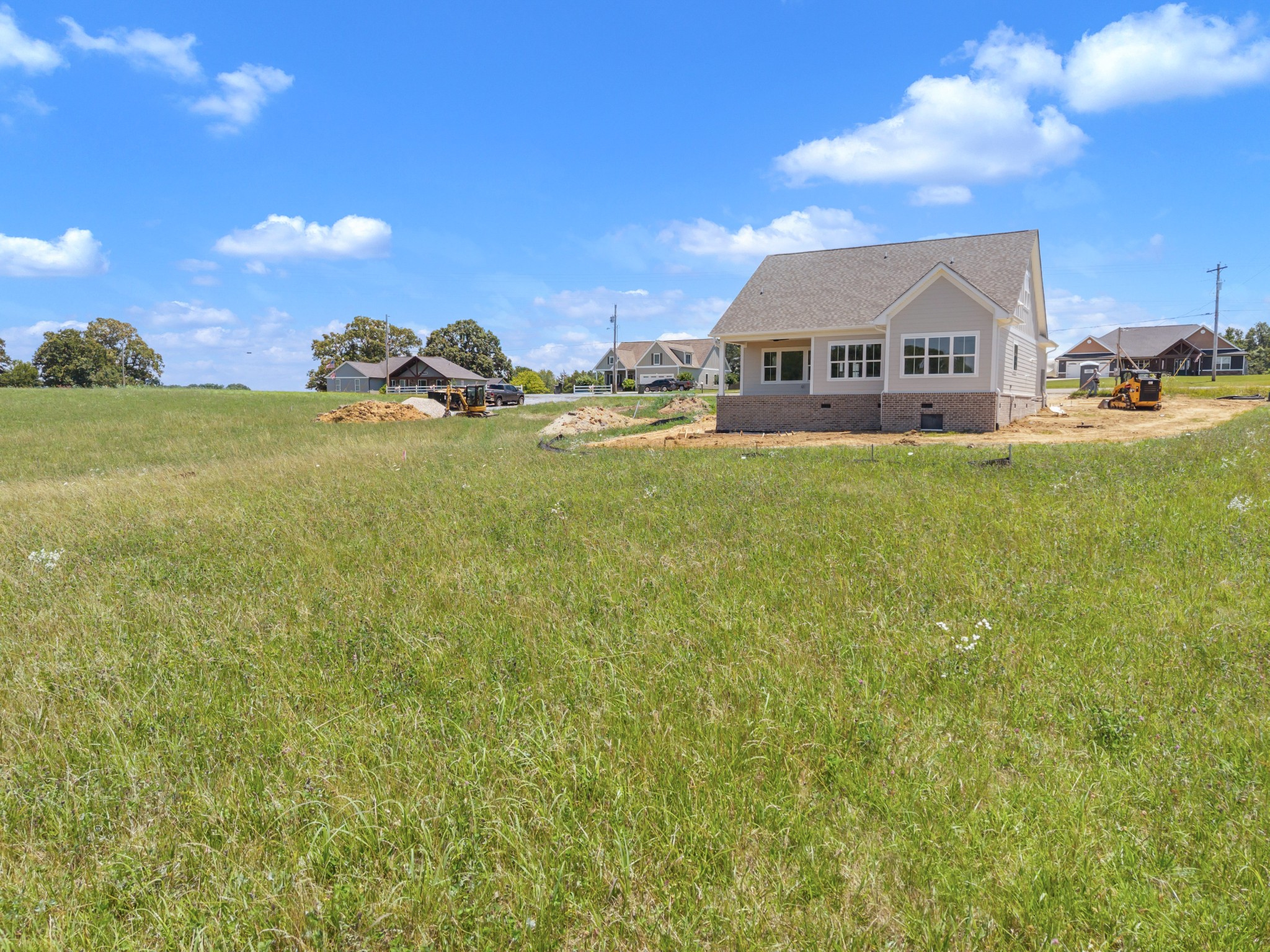 1171 Abiff Road Bon Aqua, TN 37025 - Photo 35 of 45 a view of a house next to a big yard with plants and large trees