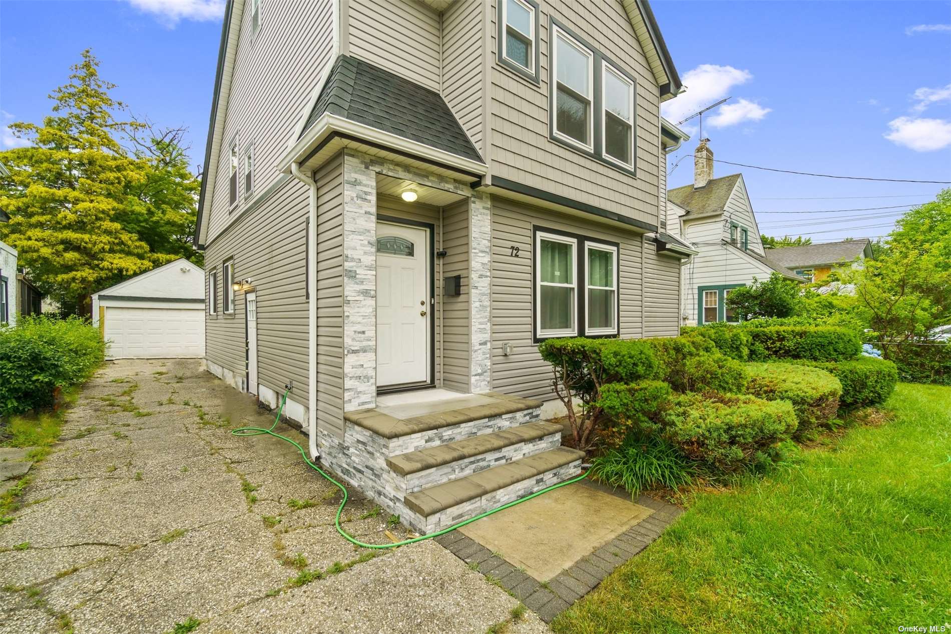 72 Courtenay Road Hempstead, NY 11550 - Photo 1 of 1 a view of a house with many windows plants and large tree