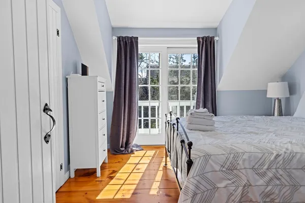 a bedroom with a bed and a lamp on table