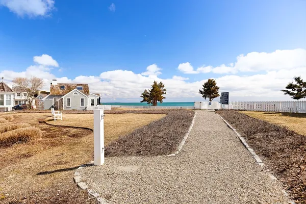 a view of a house with wooden fence