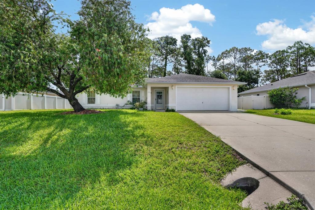 80 Roxboro Drive Palm Coast, FL 32164 - Photo 1 of 39 a front view of house with yard and green space