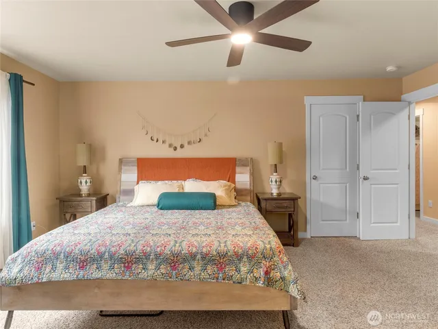a bedroom with a large bed and a chandelier