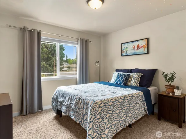 a bedroom with a large bed and a window