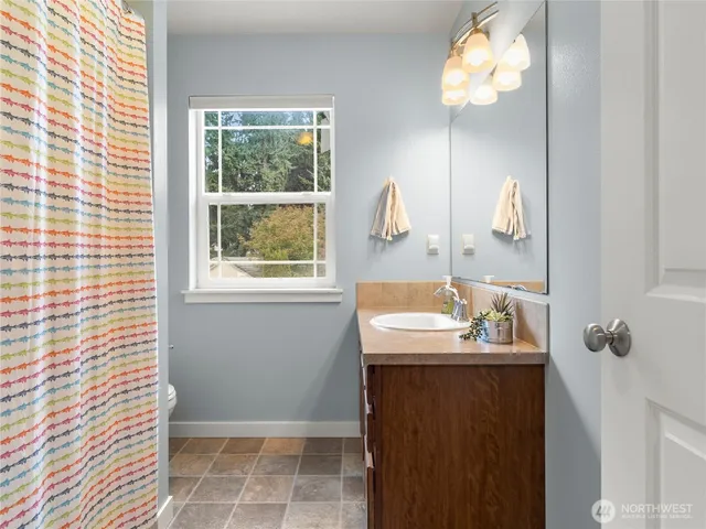a bathroom with a sink a mirror and window