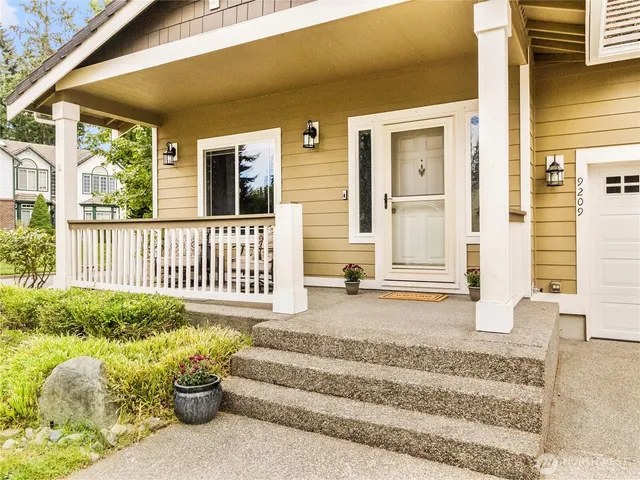 a view of porch with wooden stairs