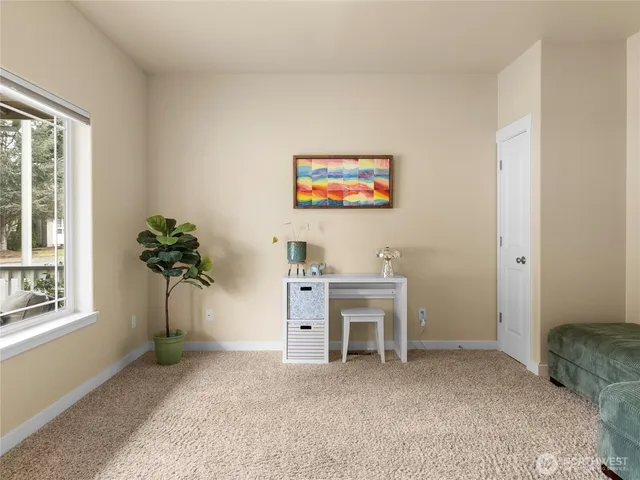 a view of a workspace with furniture and a potted plant