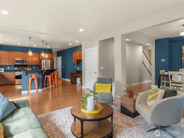 a living room with furniture and a view of kitchen
