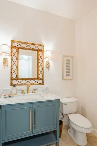 a bathroom with a toilet sink and mirror