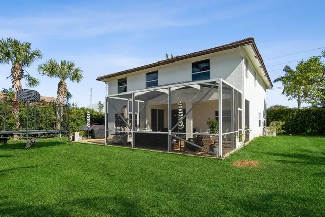 a view of a house with a yard and sitting area