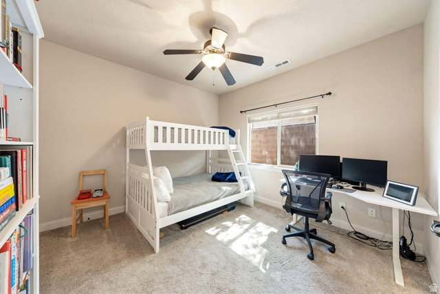1609 East 10 S Street St. George, UT 84790 - Photo 34 of 68 Bedroom featuring neutral-toned walls, plush carpet, and a ceiling fan with integrated lighting