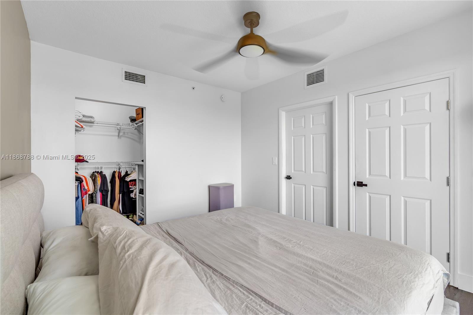 1723 Southwest 2nd Avenue, Unit 902 Miami, FL 33129 - Photo 20 of 33 a bed room with a bed and a view of walk in closet