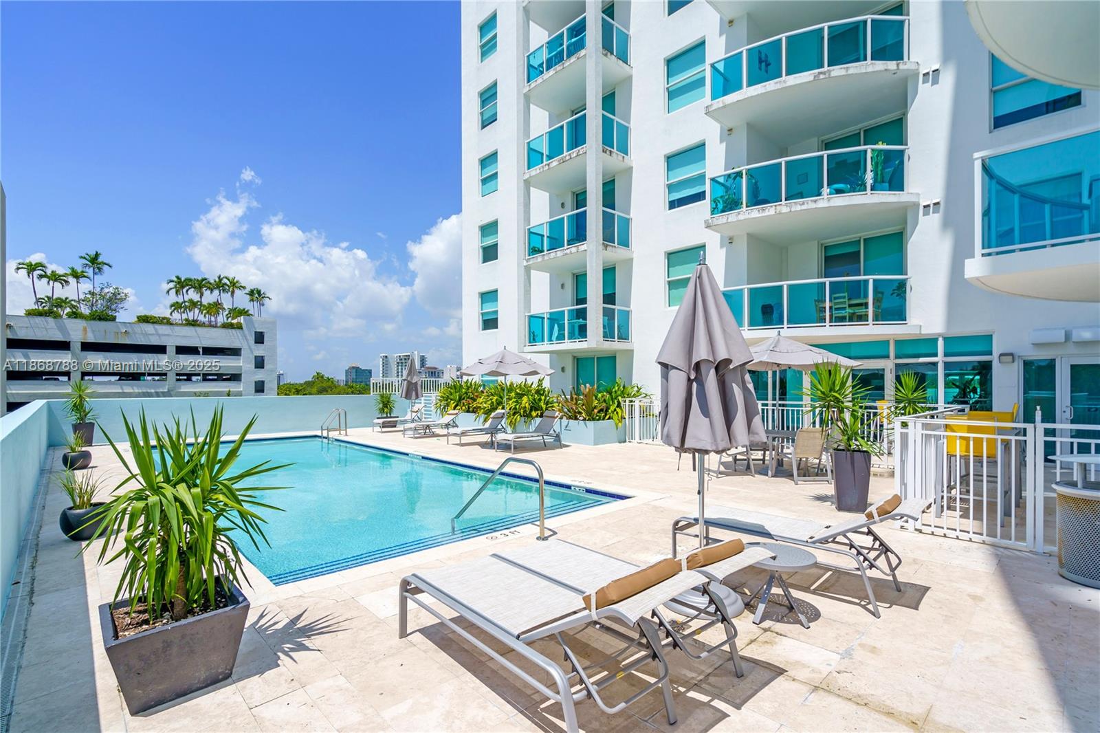 1723 Southwest 2nd Avenue, Unit 902 Miami, FL 33129 - Photo 26 of 33 a view of a swimming pool with a lounge chairs