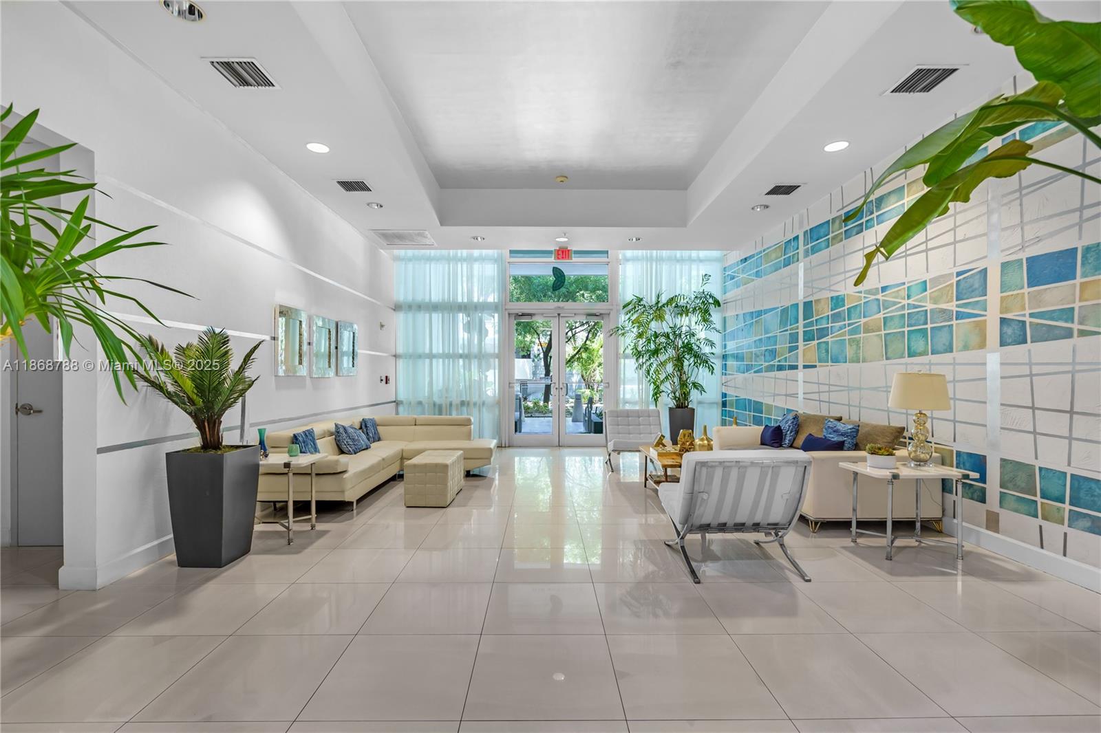 1723 Southwest 2nd Avenue, Unit 902 Miami, FL 33129 - Photo 3 of 33 a living room with patio furniture and a potted plant