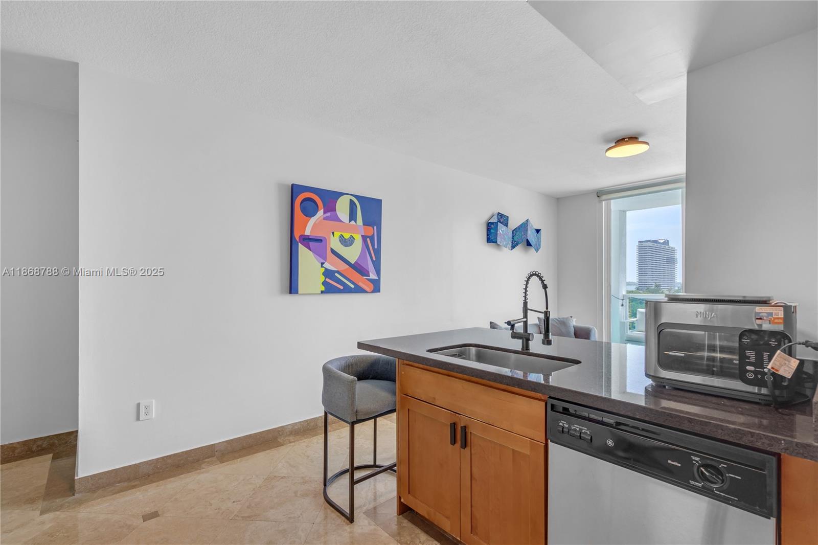 1723 Southwest 2nd Avenue, Unit 902 Miami, FL 33129 - Photo 6 of 33 a kitchen with stainless steel appliances a refrigerator and a stove top oven
