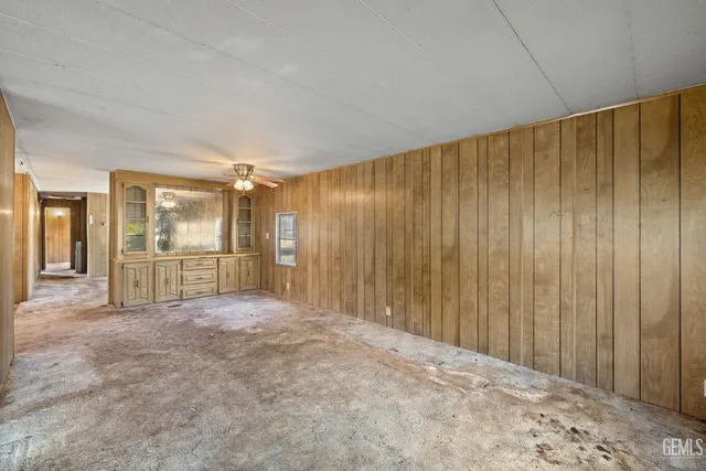 a view of an empty room with wooden walls