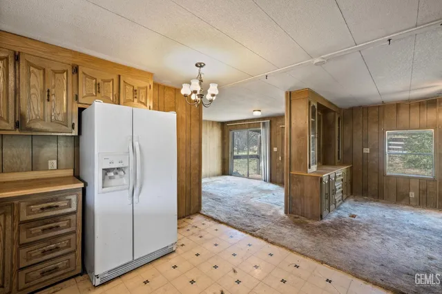 a kitchen with stainless steel appliances kitchen island granite countertop a refrigerator and cabinets
