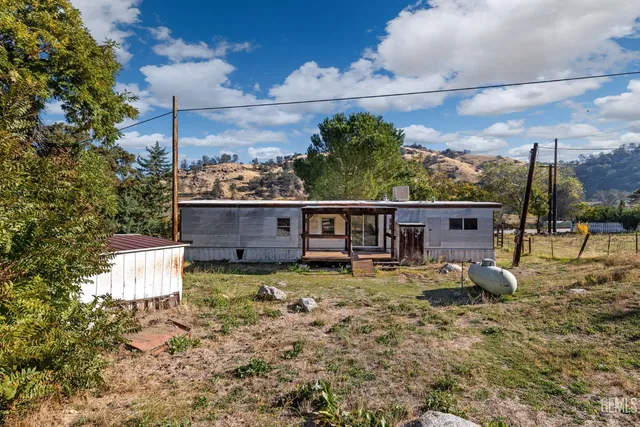 a view of a yard with wooden fence