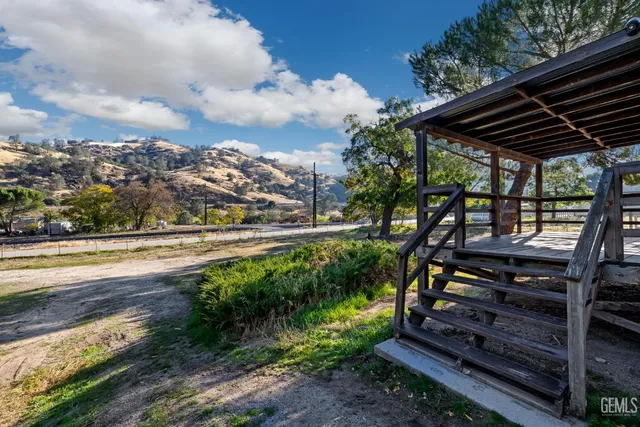 a view of a backyard with sitting area