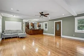 a view of a livingroom with furniture a ceiling fan and window